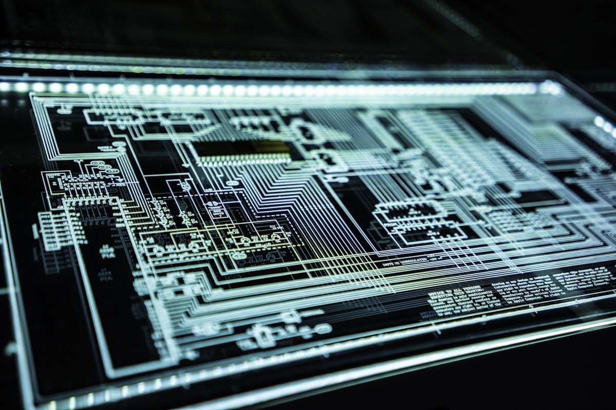 Close-up of an illuminated electronic circuit board illustrating an AI-driven cyberattack kill chain