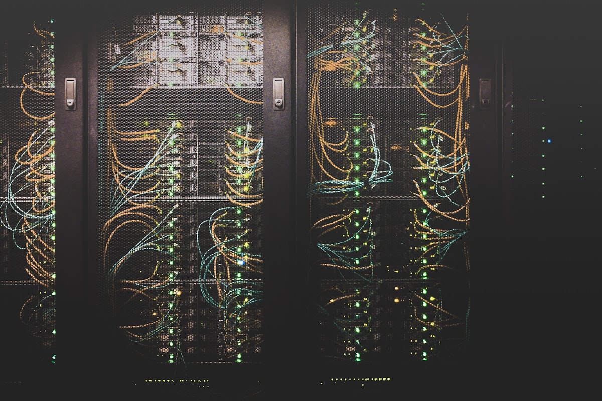 Network server racks with cabling representing the post-quantum cryptography inventory for industrial PLCs